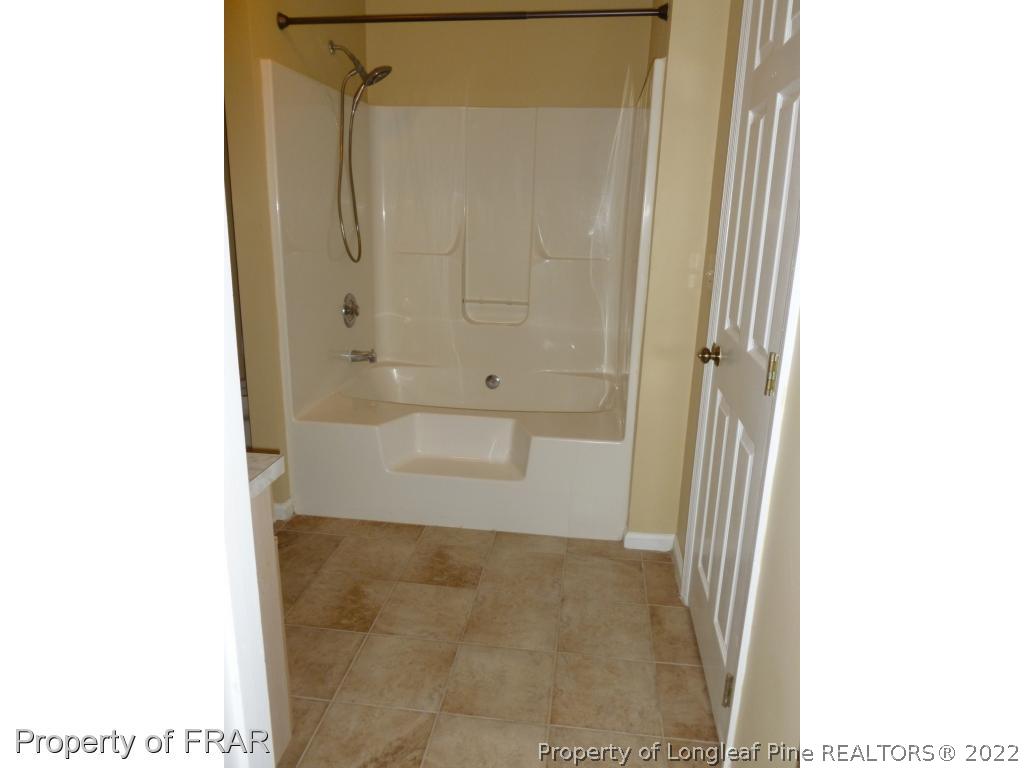 1813 Sardonyx Road Fayetteville, NC 28303 - Photo 15 of 25 a bathroom with a granite countertop shower and a sink