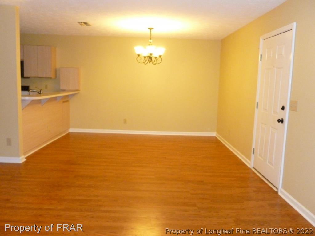 1813 Sardonyx Road Fayetteville, NC 28303 - Photo 7 of 25 a view of empty room with wooden floor