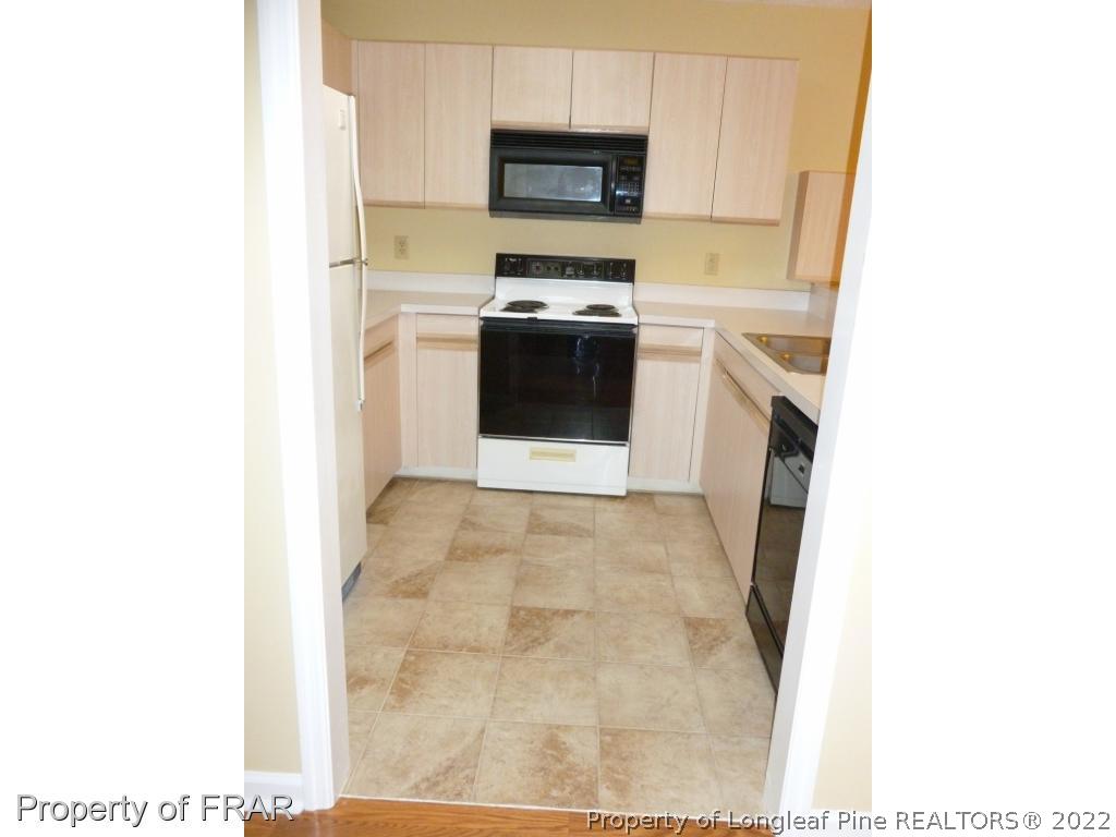 1813 Sardonyx Road Fayetteville, NC 28303 - Photo 8 of 25 a kitchen with a sink and a stove