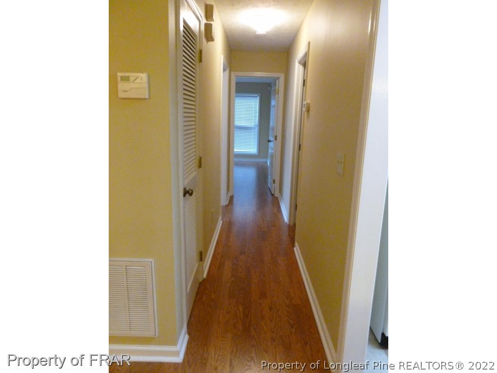 1813 Sardonyx Road Fayetteville, NC 28303 - Photo 10 of 25 a view of a hallway with wooden floor