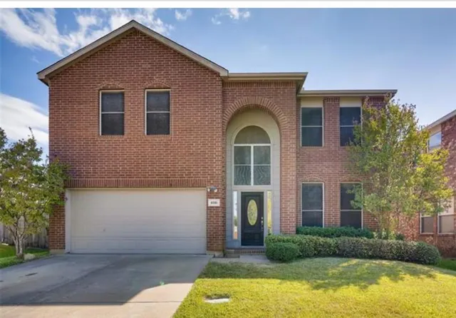 a front view of house with yard and tress