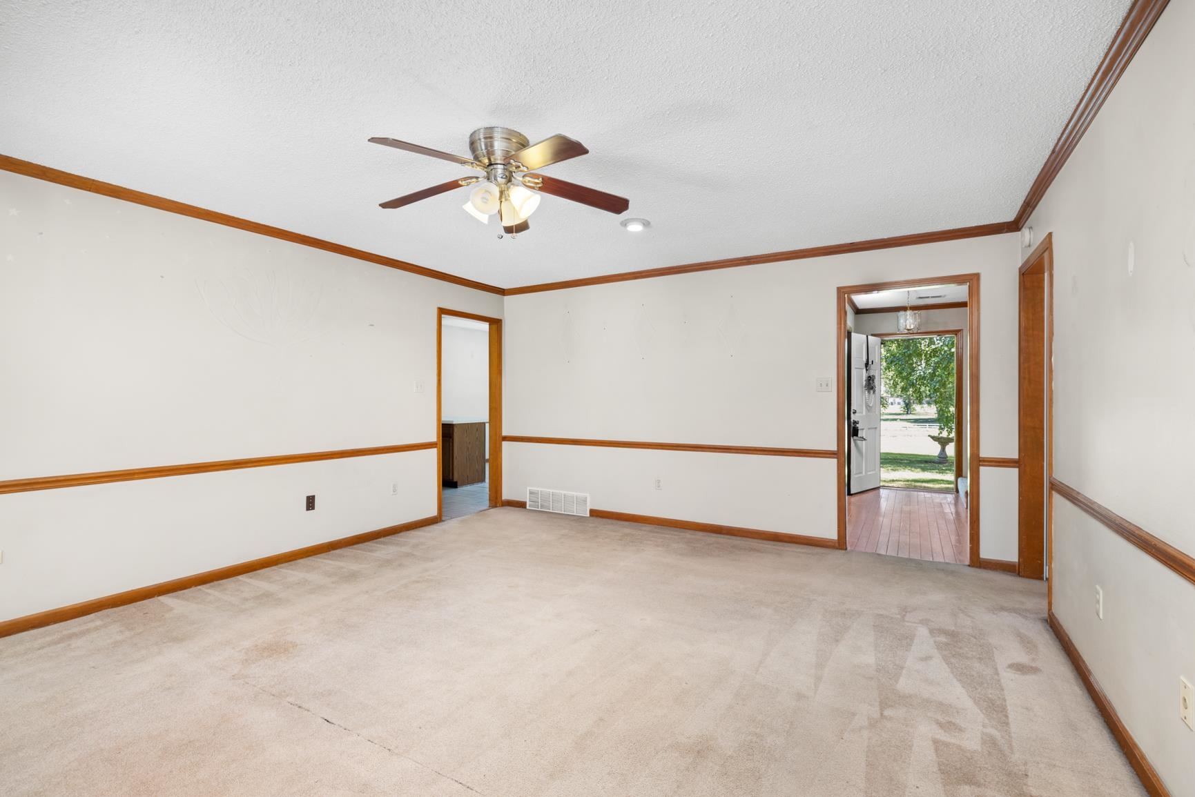 5015 Eagles Nest Lane Bartlett, TN 38002 - Photo 18 of 39 Carpeted empty room featuring crown molding, a ceiling fan, and a textured ceiling