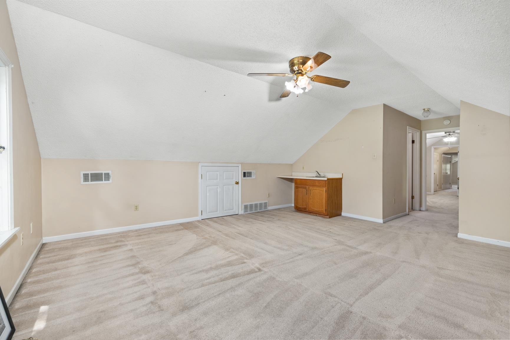 5015 Eagles Nest Lane Bartlett, TN 38002 - Photo 29 of 39 Additional living space featuring ceiling fan, light carpet, and lofted ceiling