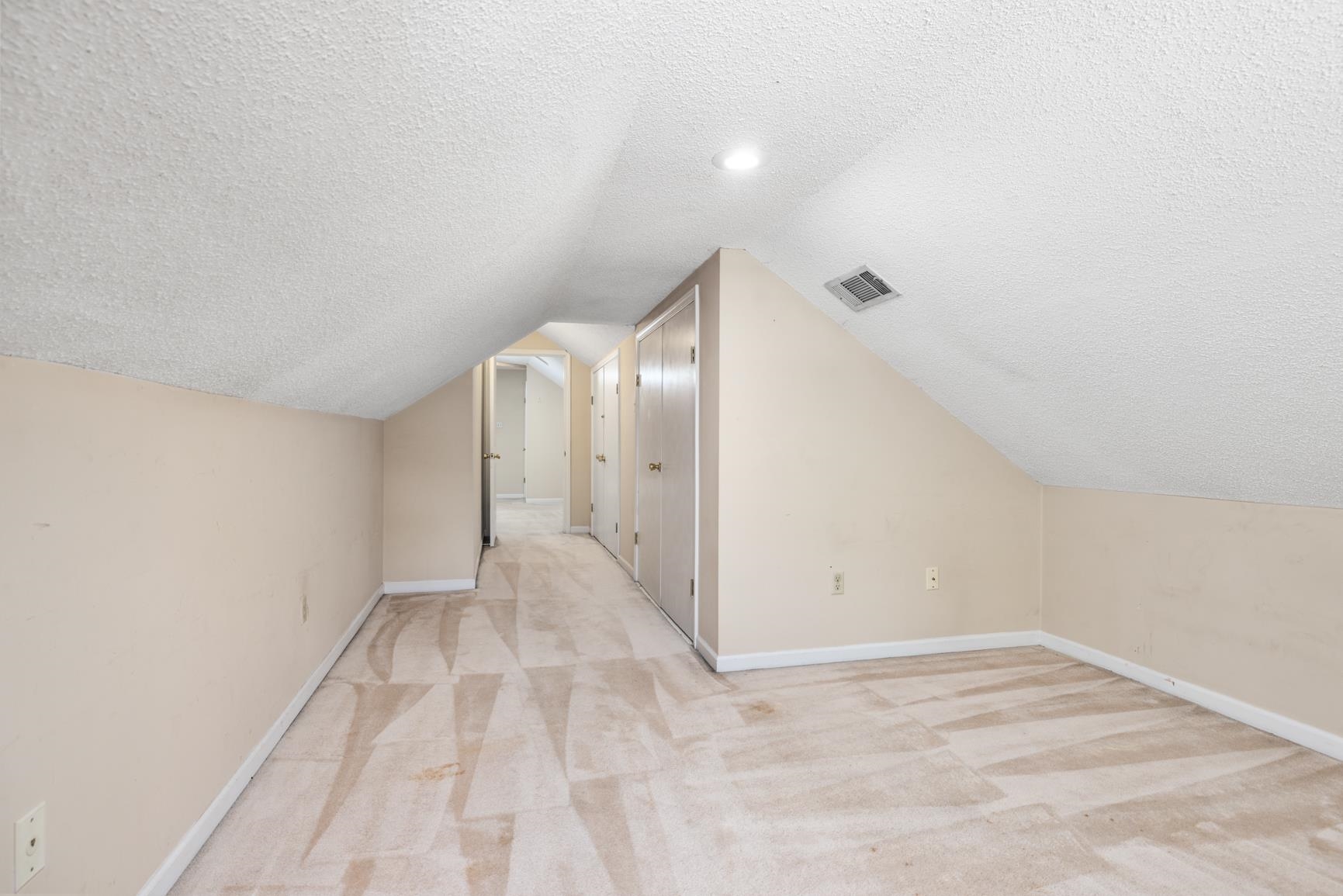 5015 Eagles Nest Lane Bartlett, TN 38002 - Photo 35 of 39 Bonus room with a textured ceiling, light carpet, and vaulted ceiling