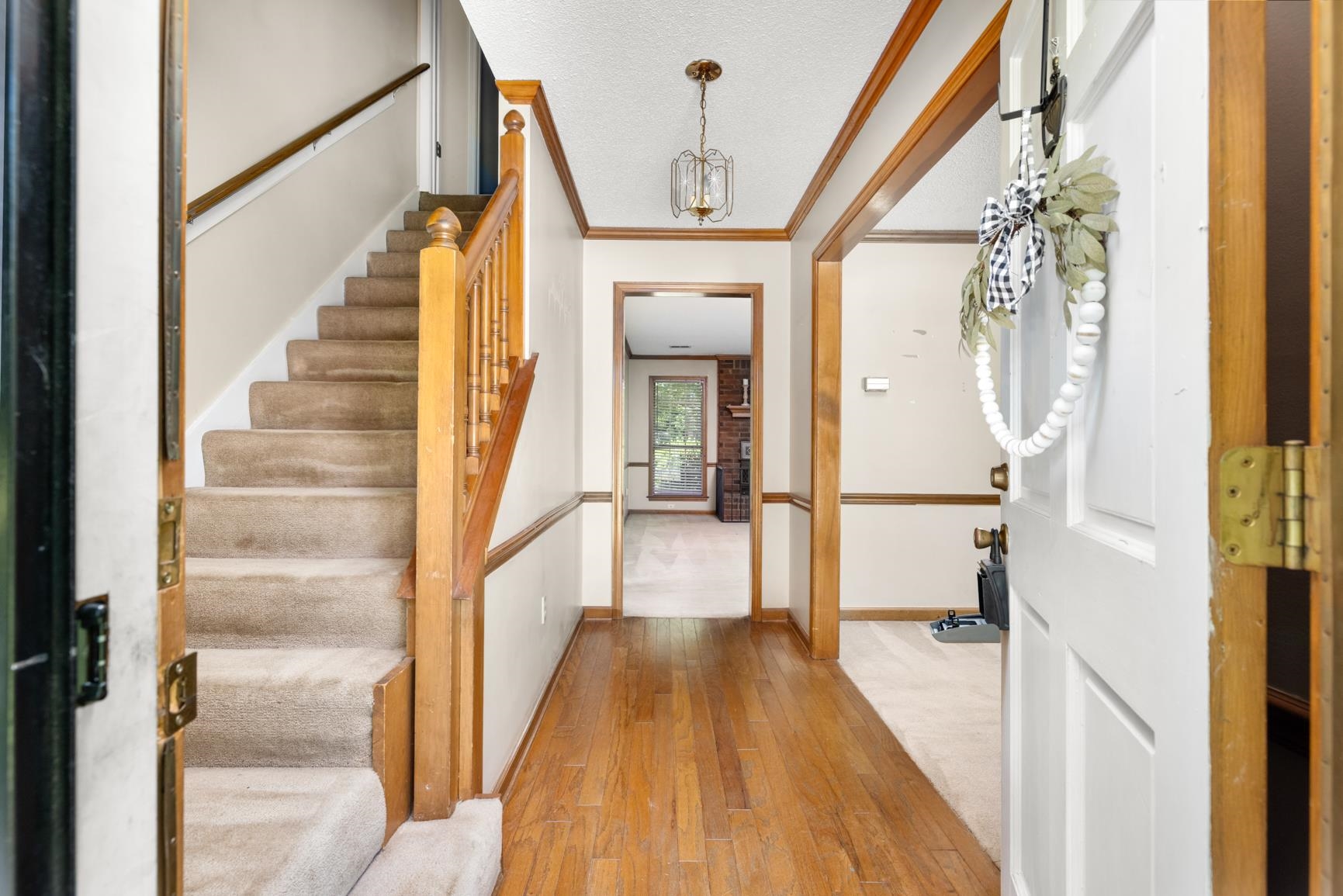 5015 Eagles Nest Lane Bartlett, TN 38002 - Photo 6 of 39 Foyer entrance with stairs, wood-type flooring, a chandelier, and crown molding