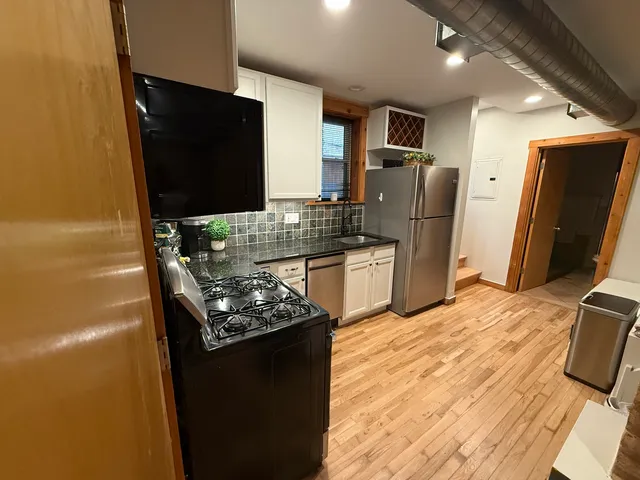a kitchen with stainless steel appliances granite countertop a refrigerator stove and oven