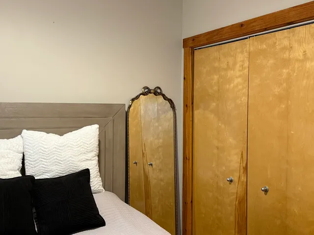 a bed room with a bed and a lamp on table