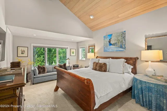 a bedroom with a large bed and a couch