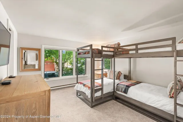 a bedroom with a bed and glass door