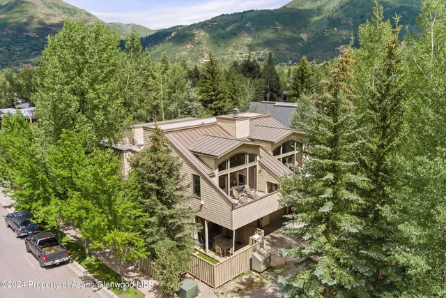 an aerial view of a house with a yard