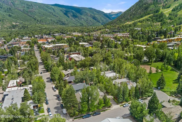 a view of a wooden house with a large trees