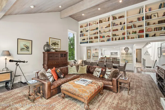 a living room with furniture and a floor to ceiling window