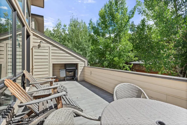 a view of two chairs in the balcony