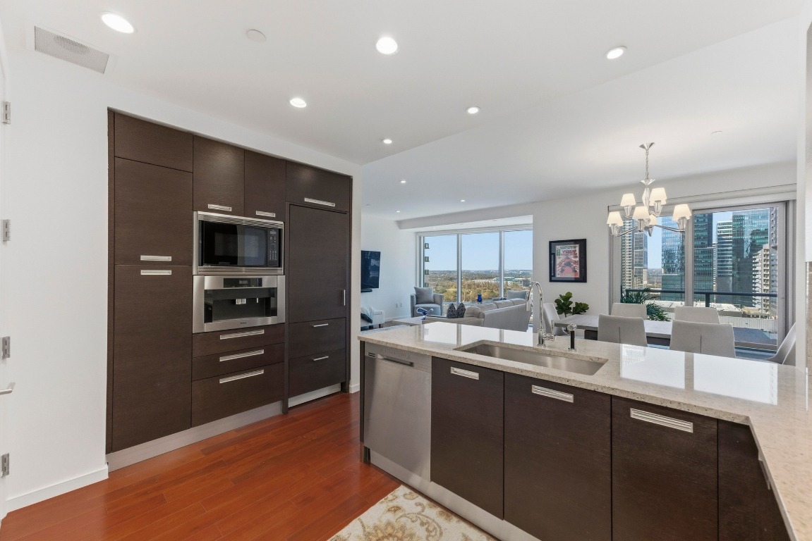 200 Congress Avenue, Unit 14A Austin, TX 78701 - Photo 40 of 40 a kitchen with counter top space cabinets and appliances