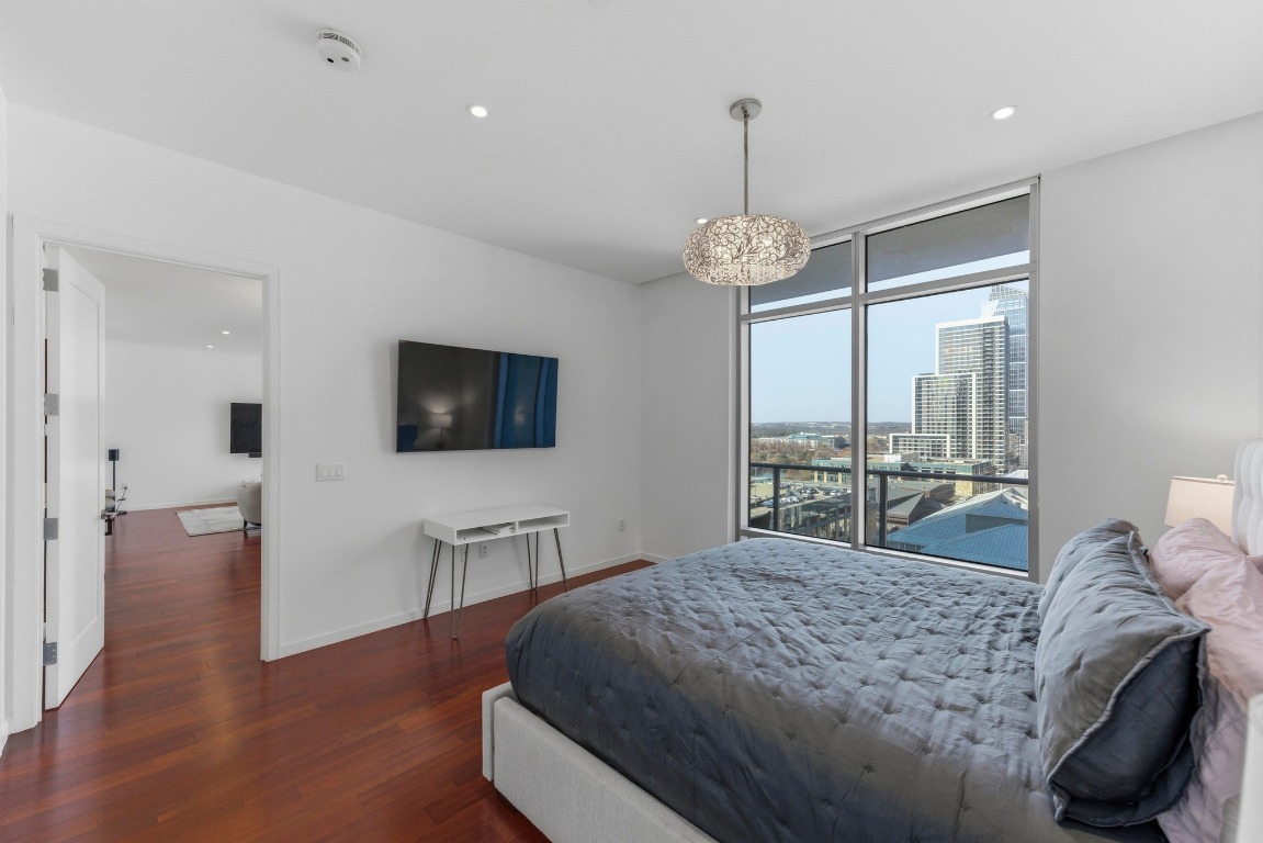 200 Congress Avenue, Unit 14A Austin, TX 78701 - Photo 17 of 40 a bedroom with a bed and a flat screen tv