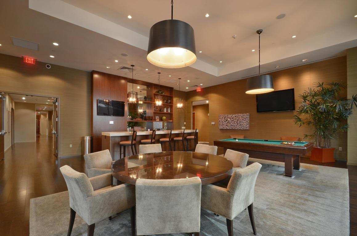 200 Congress Avenue, Unit 14A Austin, TX 78701 - Photo 39 of 40 a living room with furniture and a flat screen tv