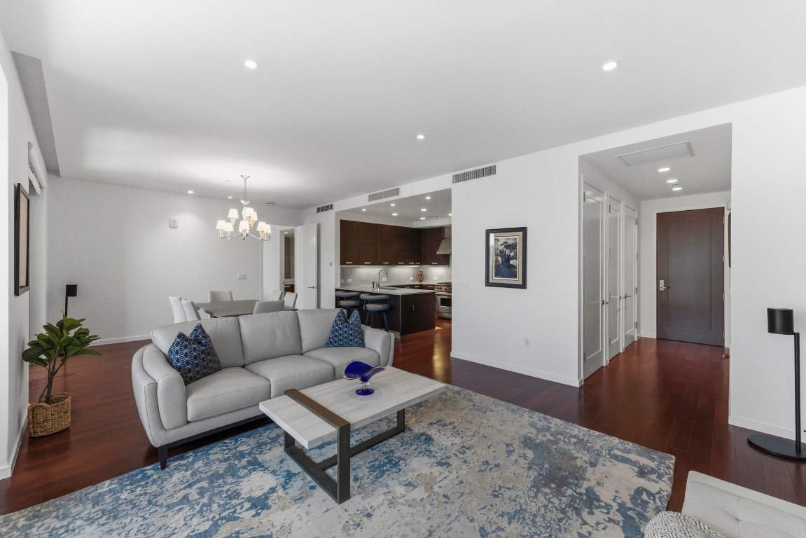 200 Congress Avenue, Unit 14A Austin, TX 78701 - Photo 4 of 40 a living room with furniture and a flat screen tv