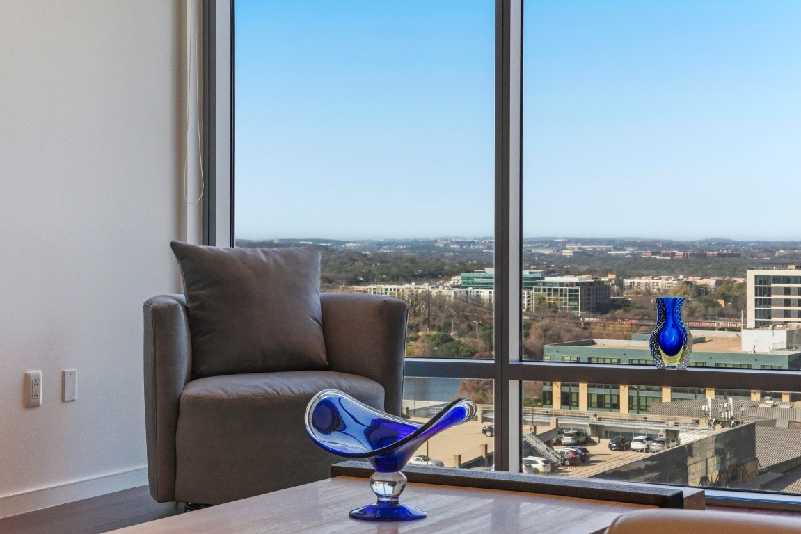 200 Congress Avenue, Unit 14A Austin, TX 78701 - Photo 6 of 40 a view of a living room with a floor to ceiling window and wooden floor