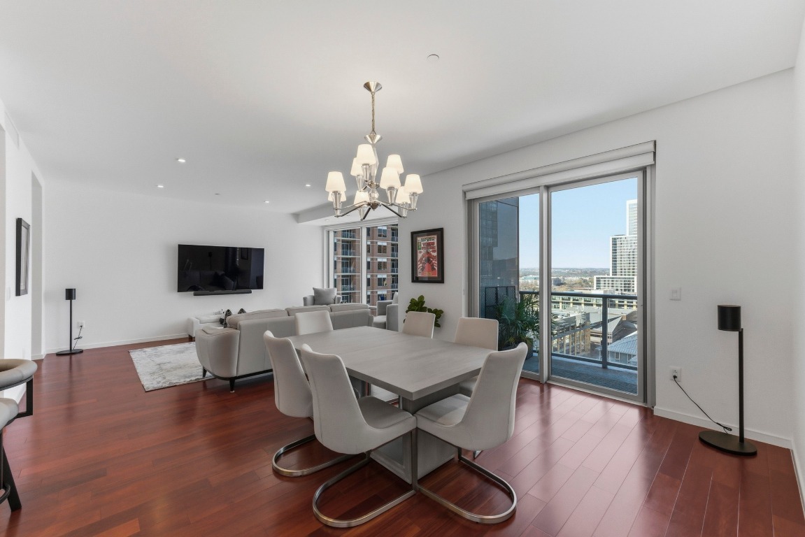 200 Congress Avenue, Unit 14A Austin, TX 78701 - Photo 8 of 40 a view of a dining room with furniture window and wooden floor