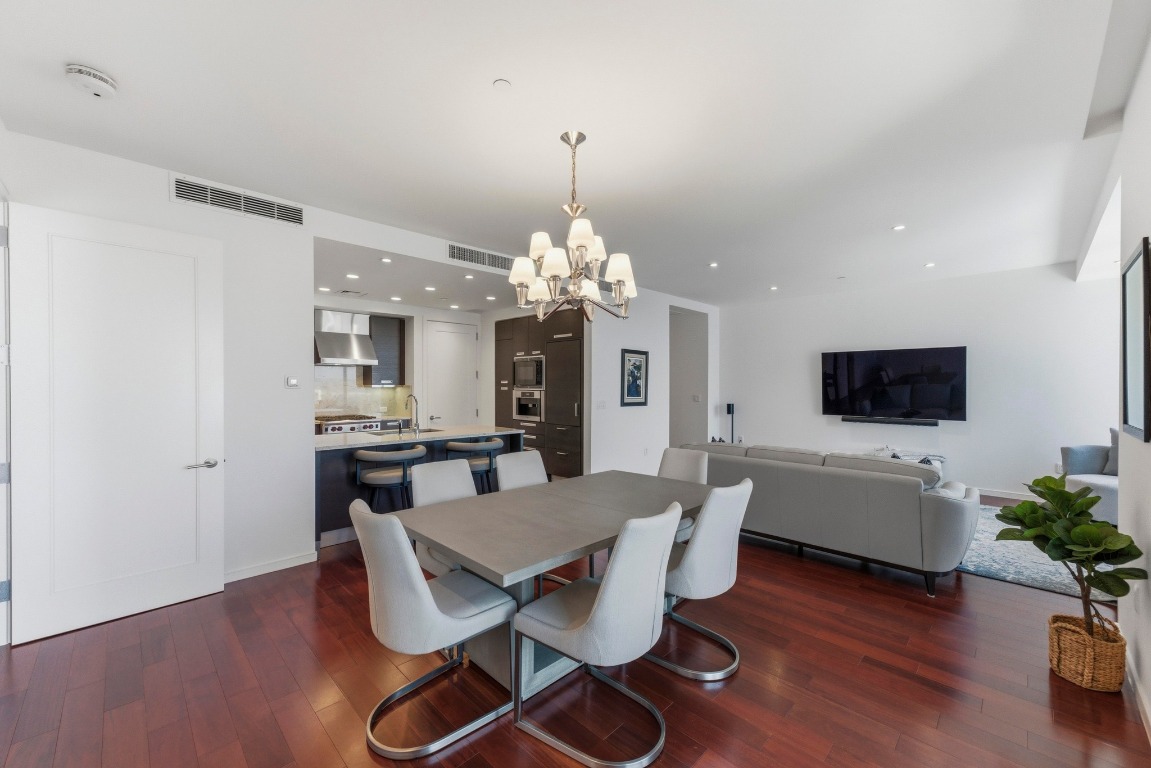 200 Congress Avenue, Unit 14A Austin, TX 78701 - Photo 9 of 40 a view of a dining room with furniture and wooden floor