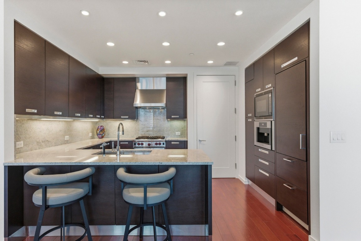 200 Congress Avenue, Unit 14A Austin, TX 78701 - Photo 10 of 40 a kitchen with kitchen island cabinets and refrigerator