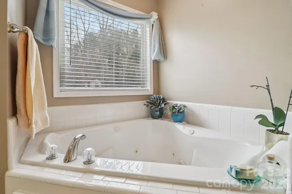 a white bath tub sitting next to a window