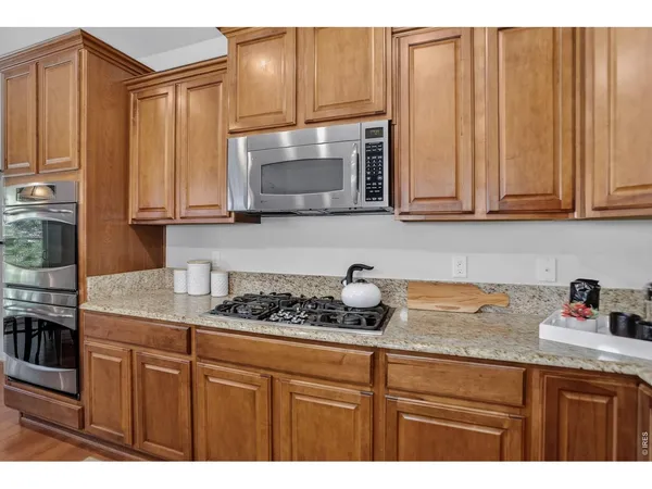 a kitchen with granite countertop stainless steel appliances and refrigerator