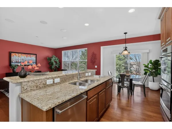 a kitchen with stainless steel appliances granite countertop a sink and refrigerator