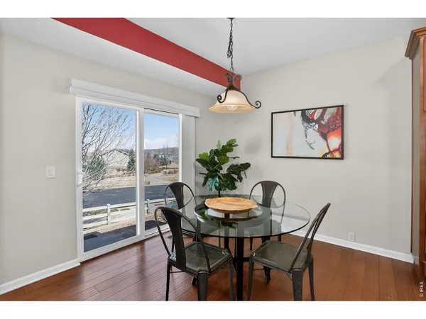 a kitchen with center island and potted plants