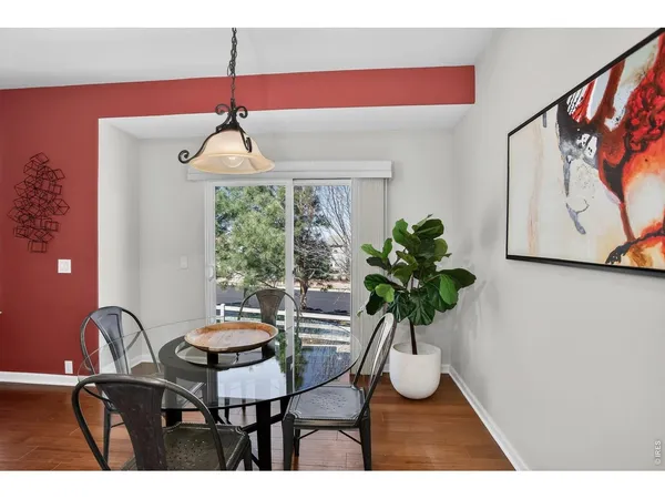 a dining room with furniture and wooden floor