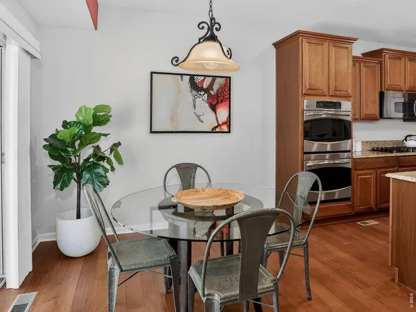 a view of a dining room with furniture wooden floor and chandelier