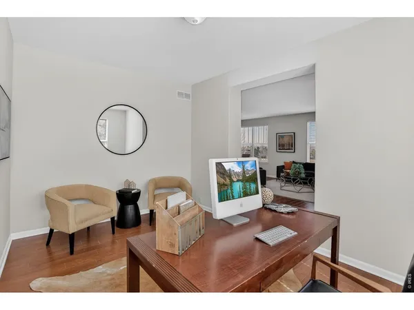 a living room with furniture and a mirror
