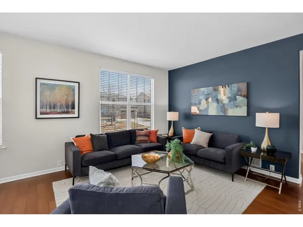 a living room with furniture a lamp and a window