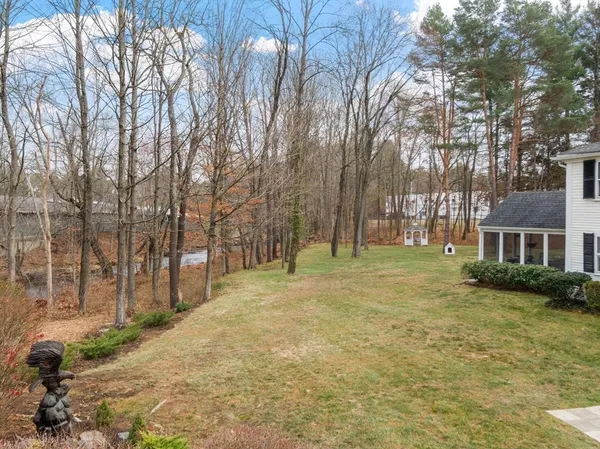 a view of residential houses with yard and trees