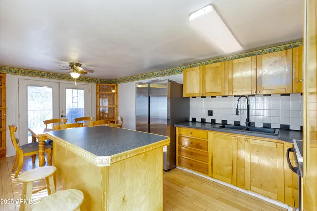 a kitchen with stainless steel appliances granite countertop a sink and a refrigerator