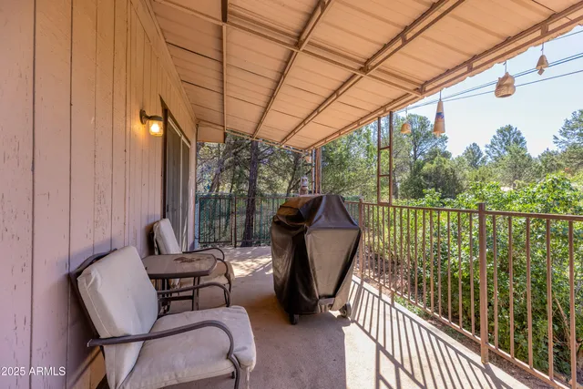 a view of a chairs and table in patio with wooden fence