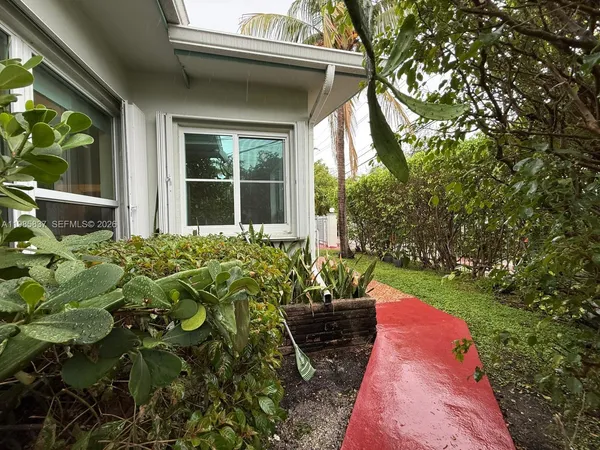 a view of a backyard with potted plants