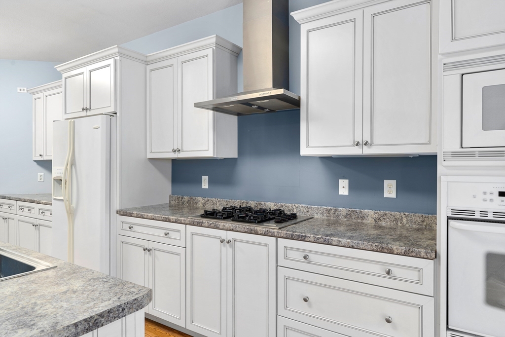 10 Golden Circle Southampton, MA 01073 - Photo 12 of 33 a kitchen with granite countertop white cabinets and a stove