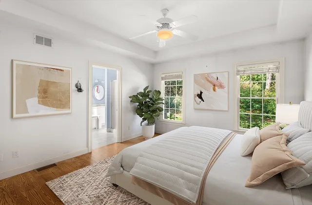 a bedroom with a large bed and a window