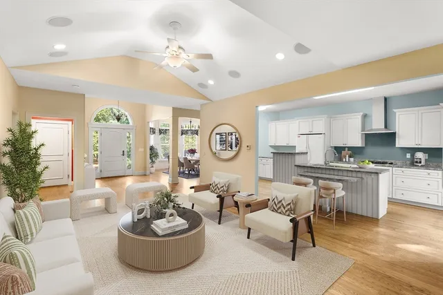 a living room with furniture a chandelier and a large mirror