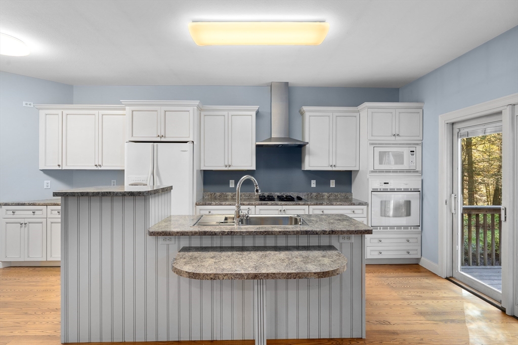 10 Golden Circle Southampton, MA 01073 - Photo 9 of 33 a kitchen with stainless steel appliances granite countertop a stove a sink and white cabinets
