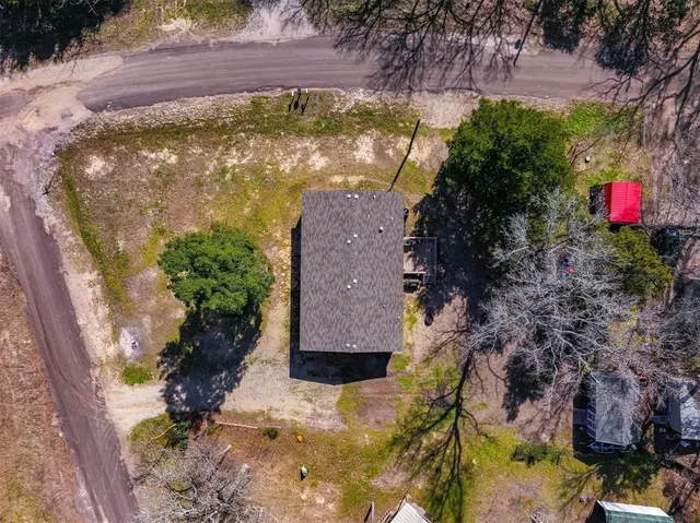 an aerial view of residential house with pool and yard