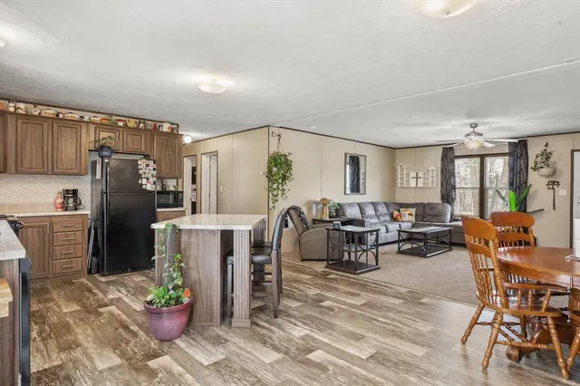 a living room with furniture a window and stainless steel appliances