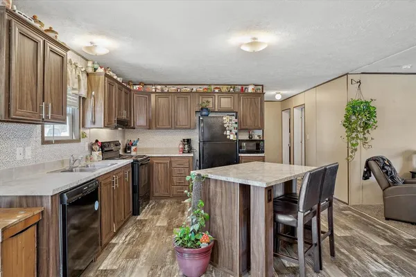a kitchen with a table chairs sink and refrigerator