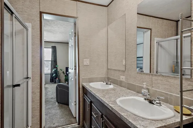 a en suite bathroom with a sink double vanity and a mirror