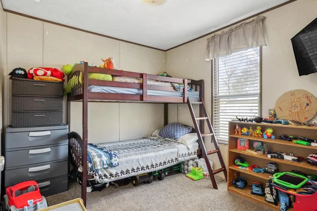 a bedroom with a bed and a wooden floor