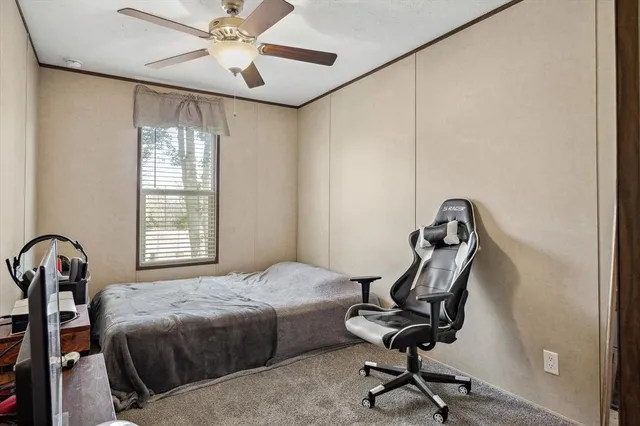 a bedroom with a bed and a desk