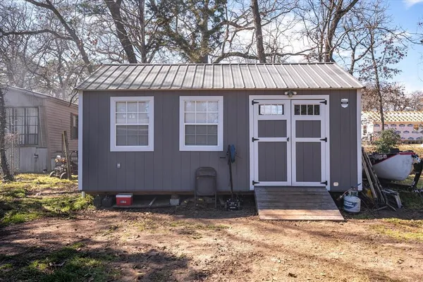 a view of a house with a yard covered with snow