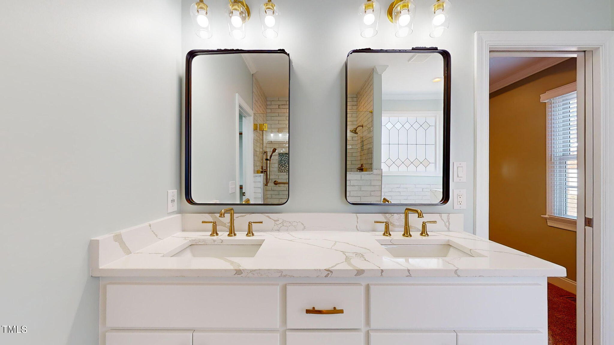 5813 Turner Store Lane Raleigh, NC 27603 - Photo 15 of 35 a bathroom with double vanity sinks and a mirror