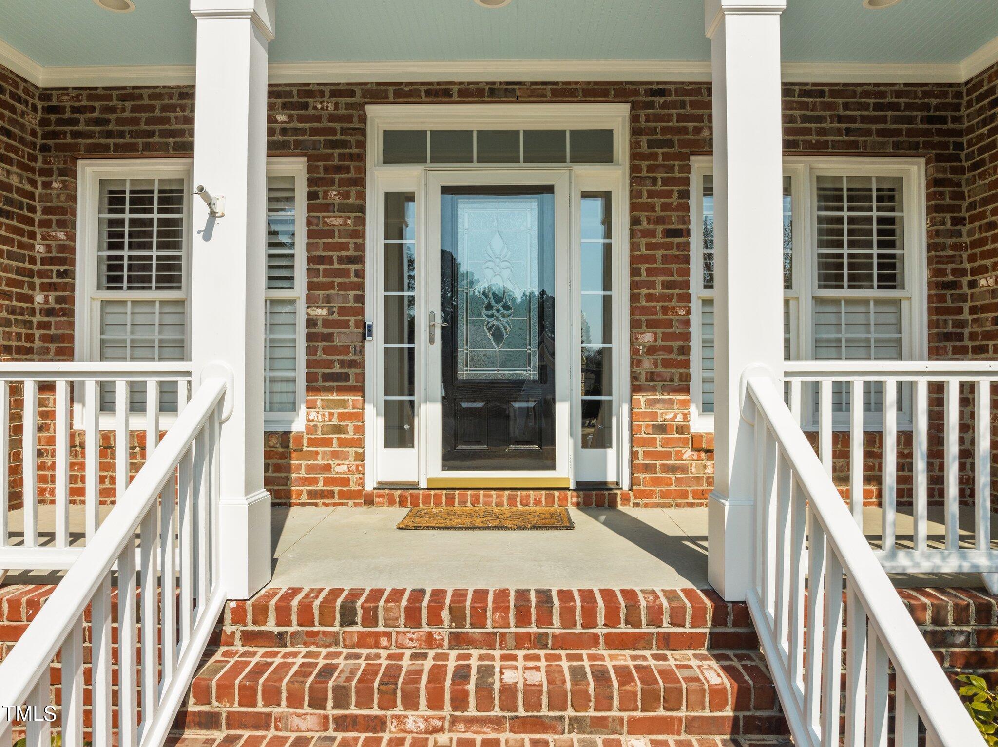 5813 Turner Store Lane Raleigh, NC 27603 - Photo 2 of 35 a view of a balcony with wooden floor and fence